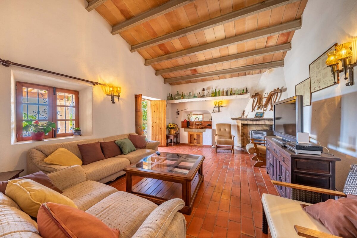 A living room with a couch a table and a television