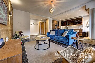 A living room with a blue couch that says mountain base on it
