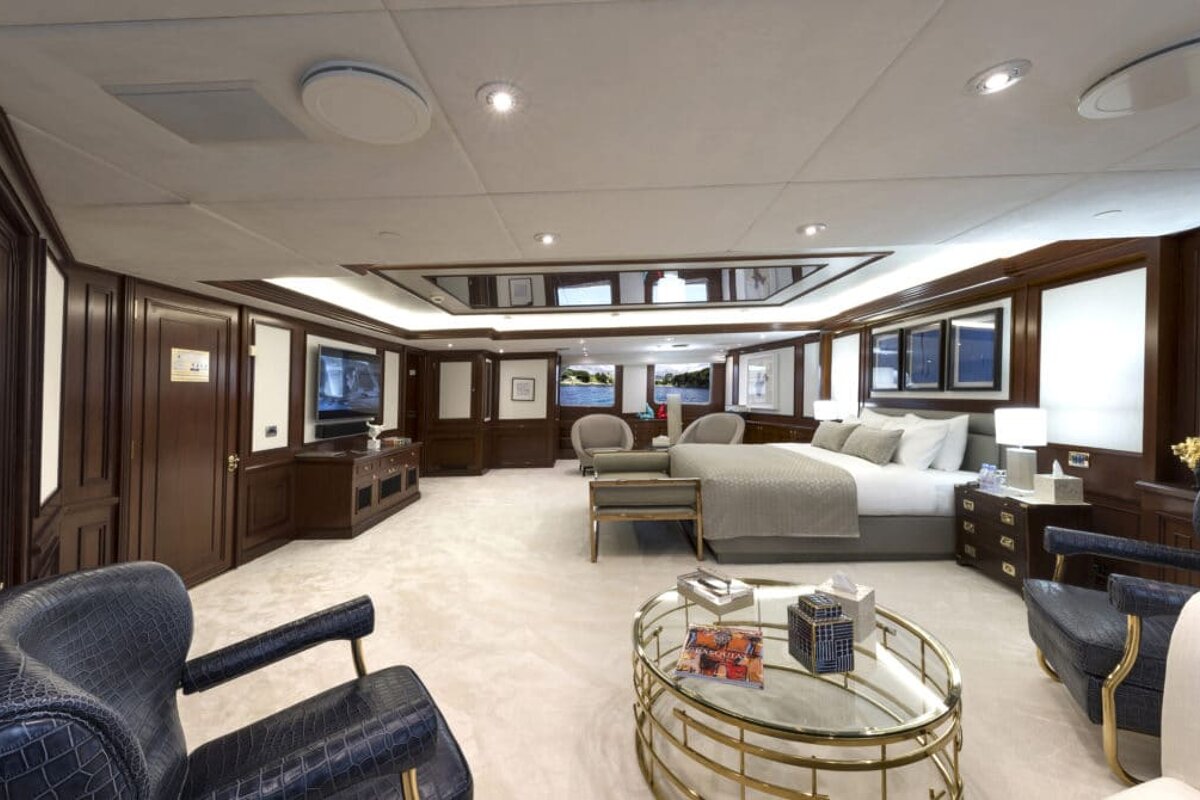 A bedroom with a large bed and a coffee table