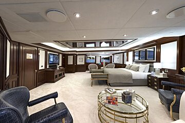 A bedroom with a large bed and a coffee table