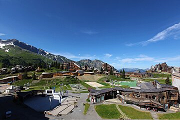 A view of a ski resort with mountains in the background