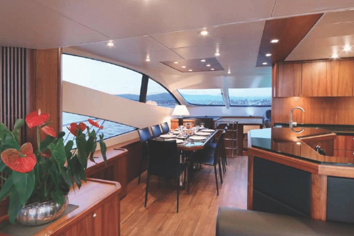 A dining room on a boat with a table and chairs