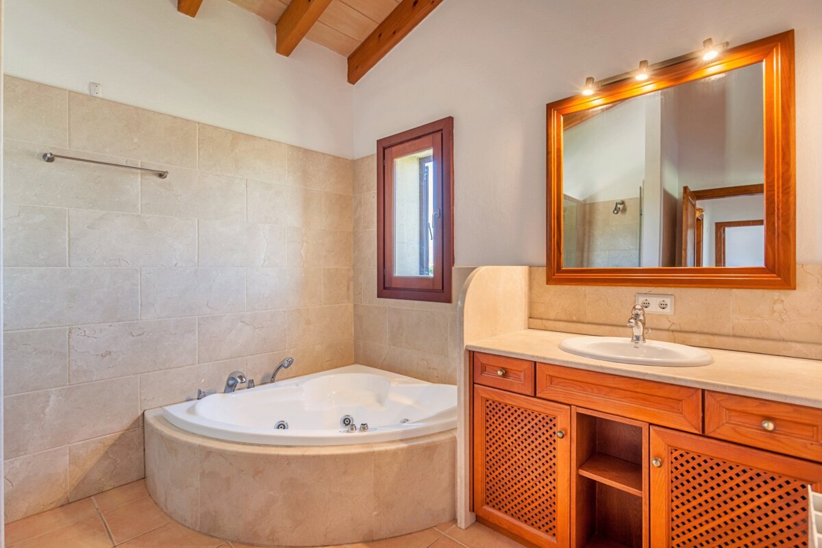 A bathroom with a jacuzzi tub and a sink