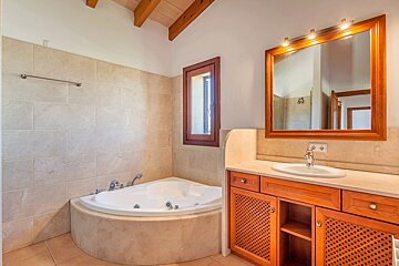 A bathroom with a jacuzzi tub and a sink