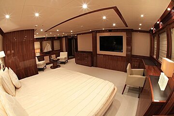 A bedroom with a large bed and a flat screen tv