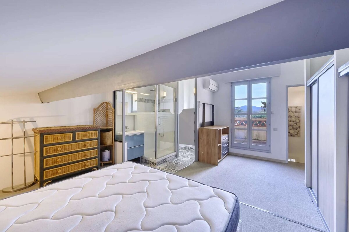 A bedroom with a mattress and a dresser