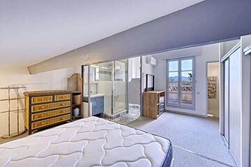 A bedroom with a mattress and a dresser