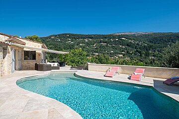 A swimming pool with mountains in the background
