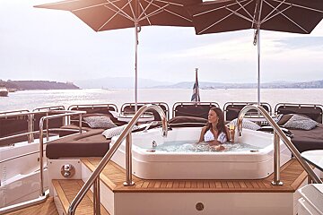 A woman is sitting in a jacuzzi on a boat