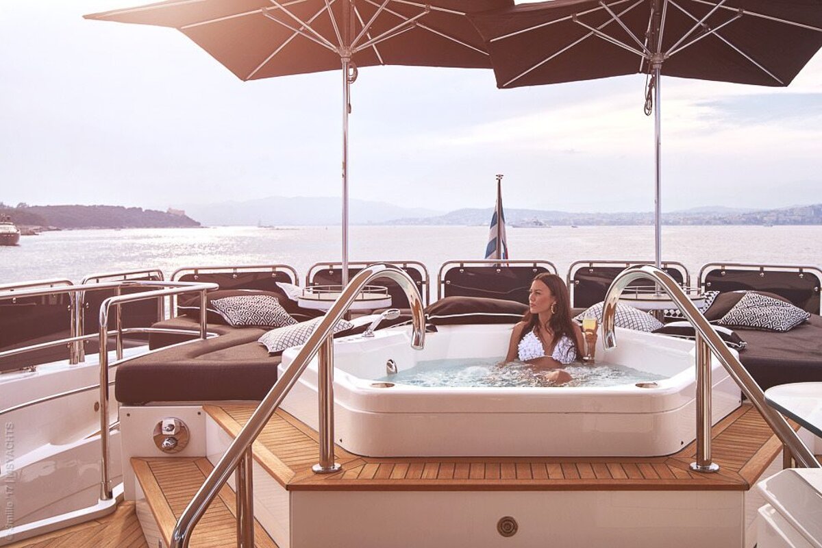 A woman is sitting in a jacuzzi on a boat