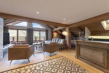 A living room with a couch and chairs and a bar