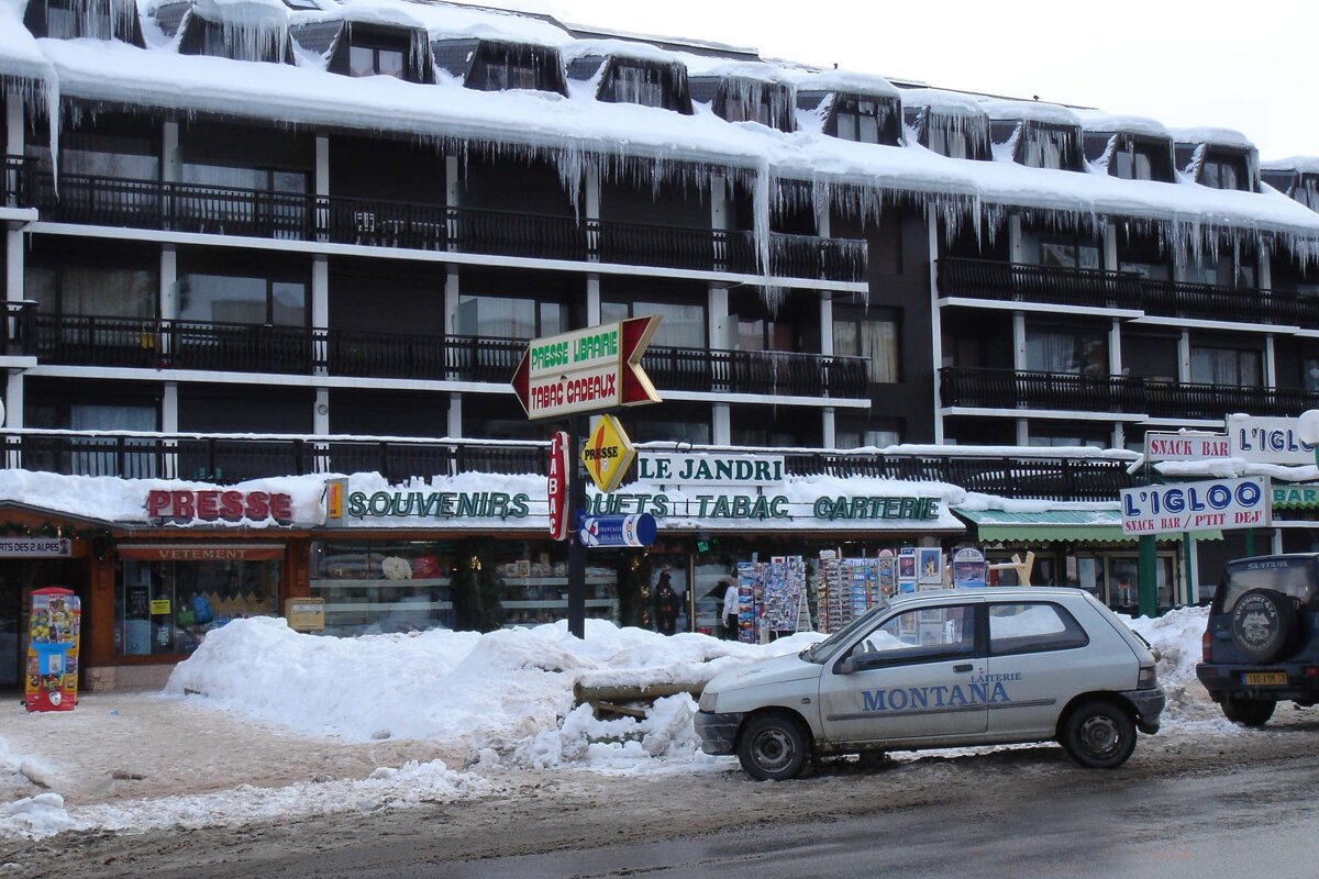 A montana car is parked in front of a snowy building