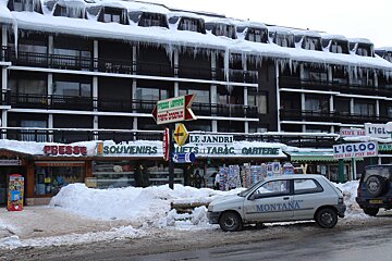 A montana car is parked in front of a snowy building