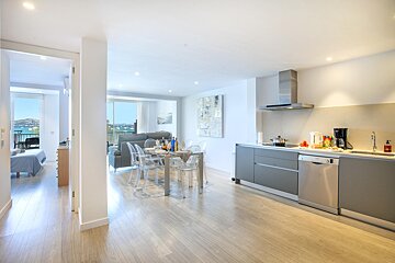 A kitchen with a table and chairs in it