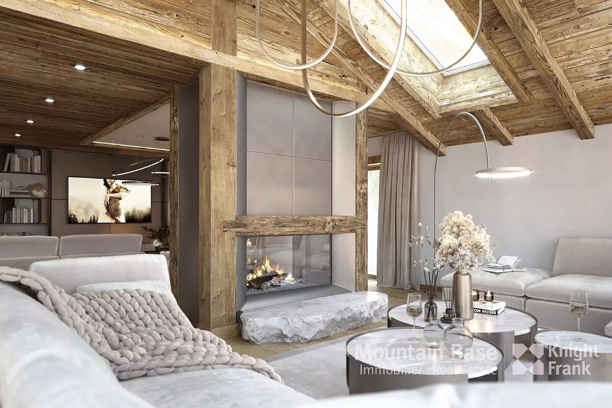 A modern, cozy living room with a prominent glass fireplace, rustic wooden beams, plush sofas, and contemporary lighting under a skylight.