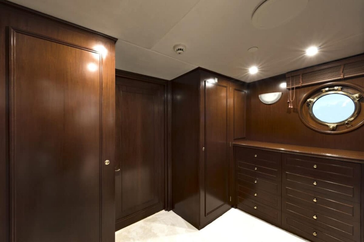 A room with wooden cabinets and a round window
