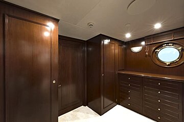 A room with wooden cabinets and a round window
