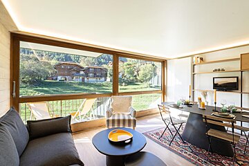 A living room with a couch a chair and a table