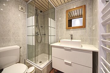 A bathroom with a toilet a sink and a shower