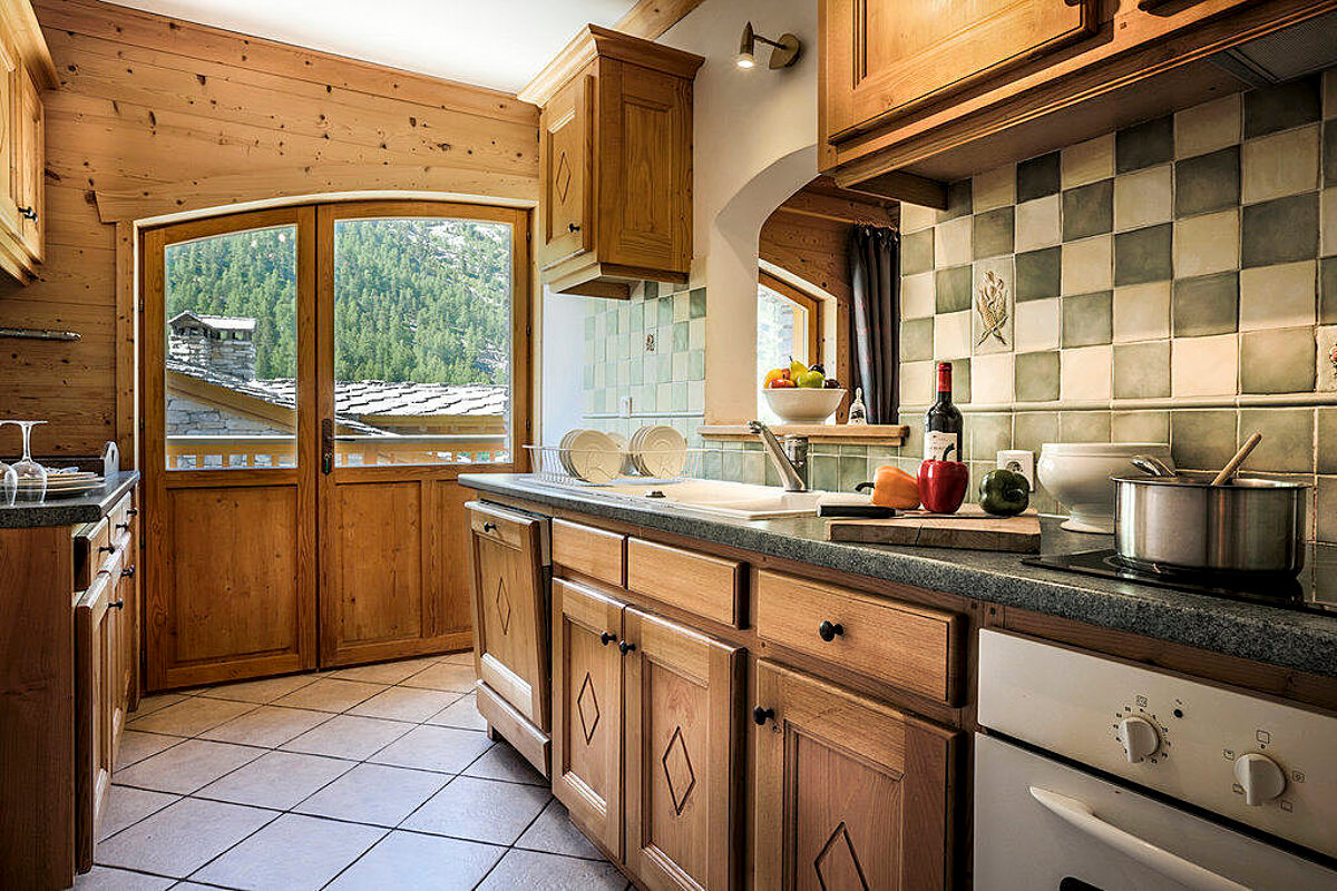 A kitchen with a bottle of wine on the counter