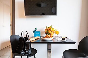 A small table with a bowl of fruit on it