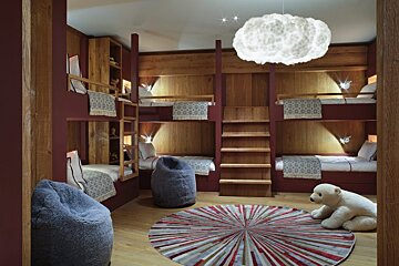 A room with bunk beds and a stuffed polar bear