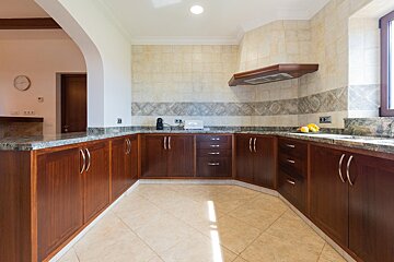 A kitchen with wooden cabinets and granite counter tops