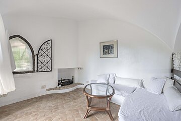 A living room with a fireplace and a picture on the wall
