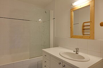 A bathroom with a sink a mirror and a bathtub