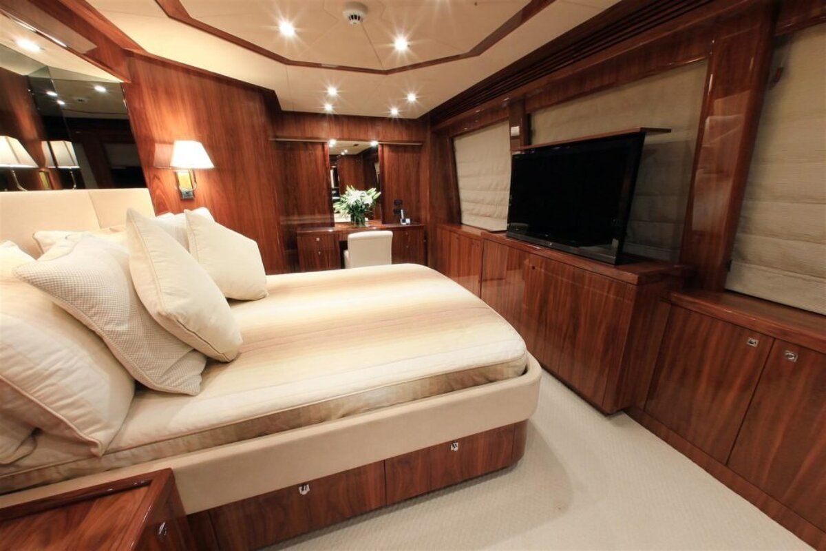 A bedroom with a large bed and a flat screen tv