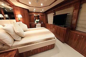 A bedroom with a large bed and a flat screen tv