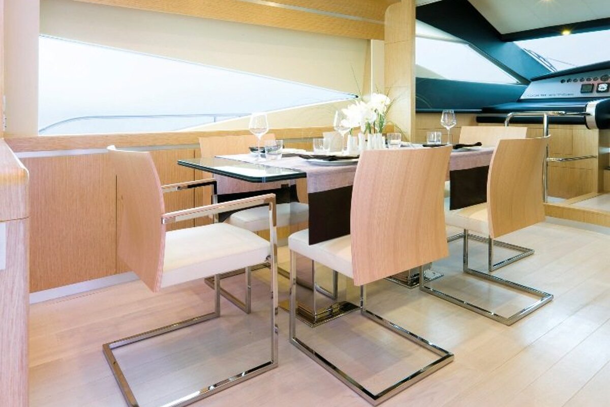 A dining room with a table and chairs and a window