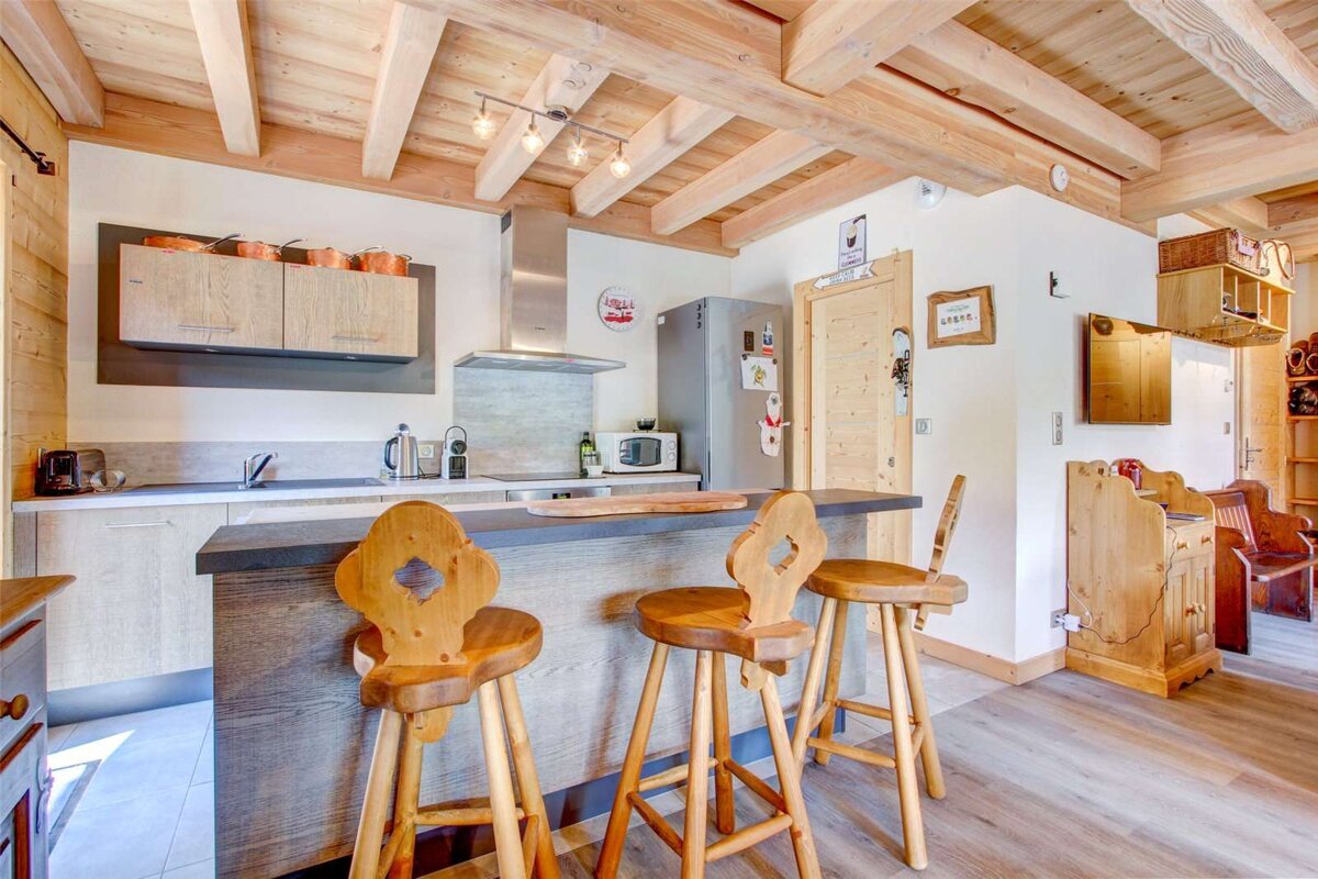 A kitchen with stools and a sign that says ' a ' on it