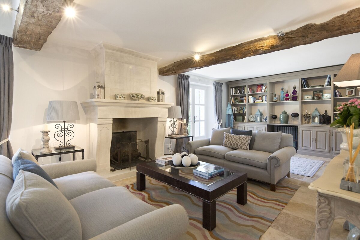 A living room with two couches and a fireplace