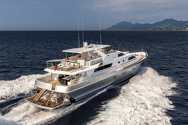 A large white yacht is floating in the ocean