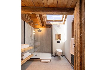 A bathroom with a skylight above the toilet
