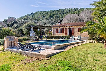 A house with a swimming pool in front of it
