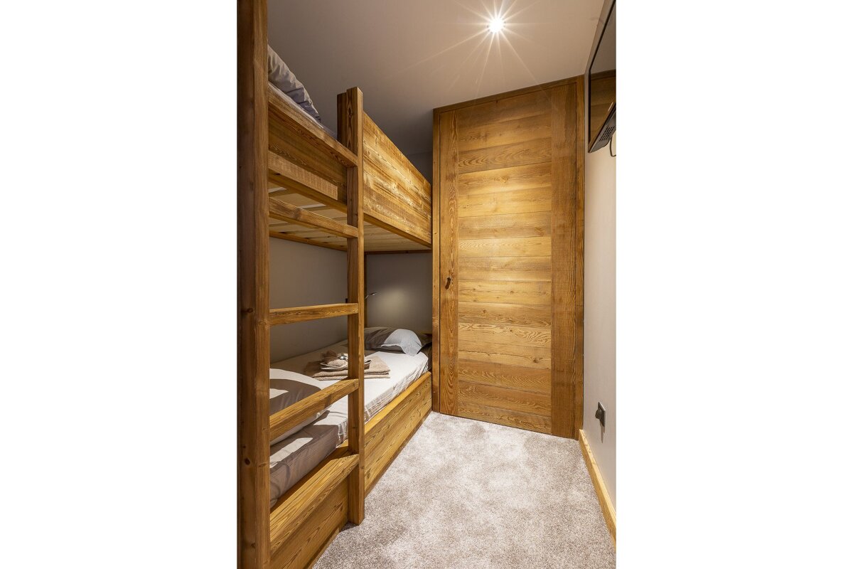 A living room with a couch a table and a chair