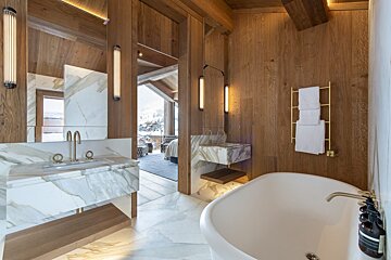 A bathroom with marble counter tops and a bathtub
