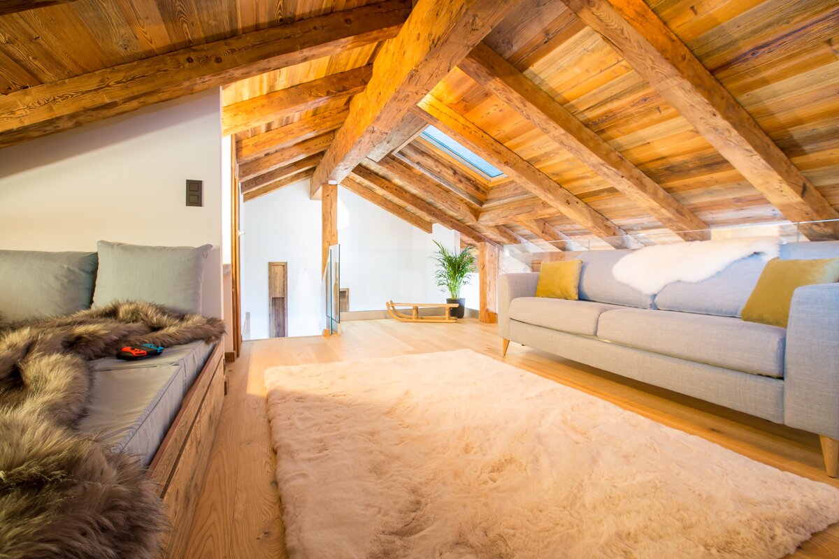 A living room with a couch and a rug