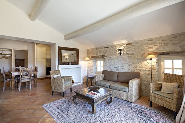 A living room with a couch and two chairs