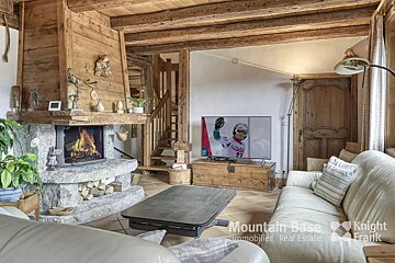 A living room with a fireplace and a television that says mountain base