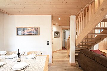 A wooden staircase leads up to the second floor of a house