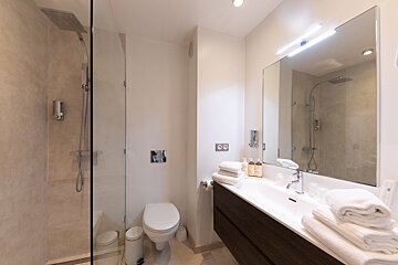 A bathroom with a toilet a sink and a shower