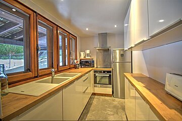 A kitchen with stainless steel appliances and white cabinets
