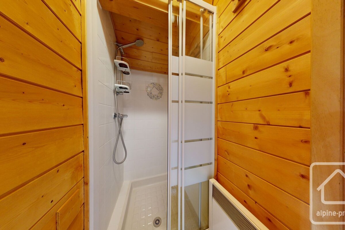 A bathroom with a shower and a sign that says alpine-pro