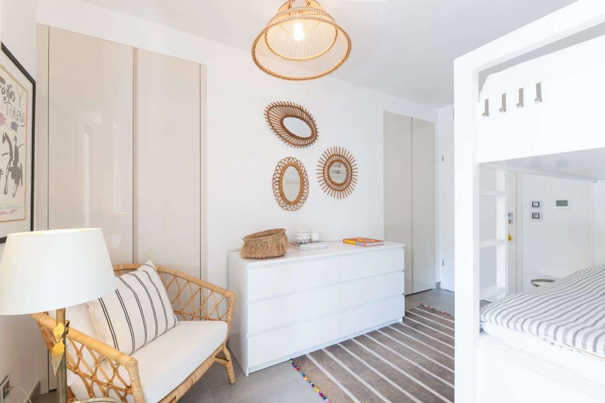 A bedroom with a bunk bed and a dresser