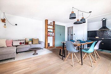 A living room with a couch and a table and chairs