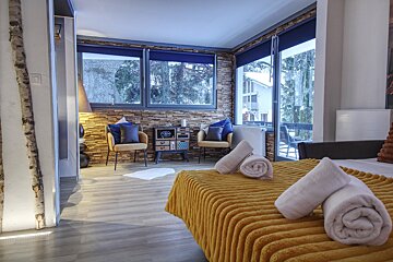 A bedroom with a large bed and a large window