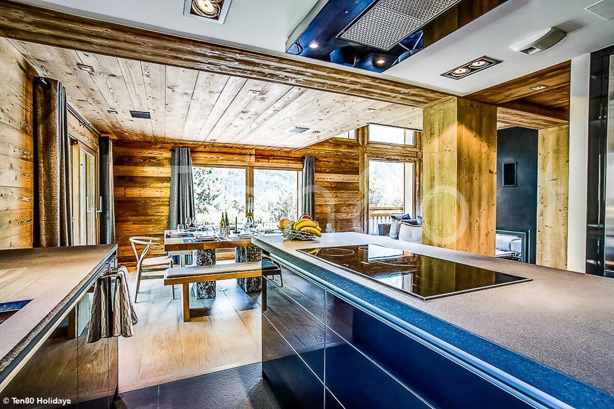 A kitchen with a large island and a stove top oven